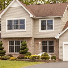 Beautiful house with SOLD sign on front lawn