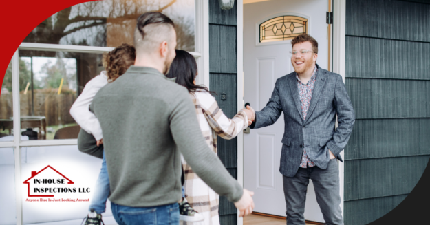 Home inspector greeting new homeowners at the front door.