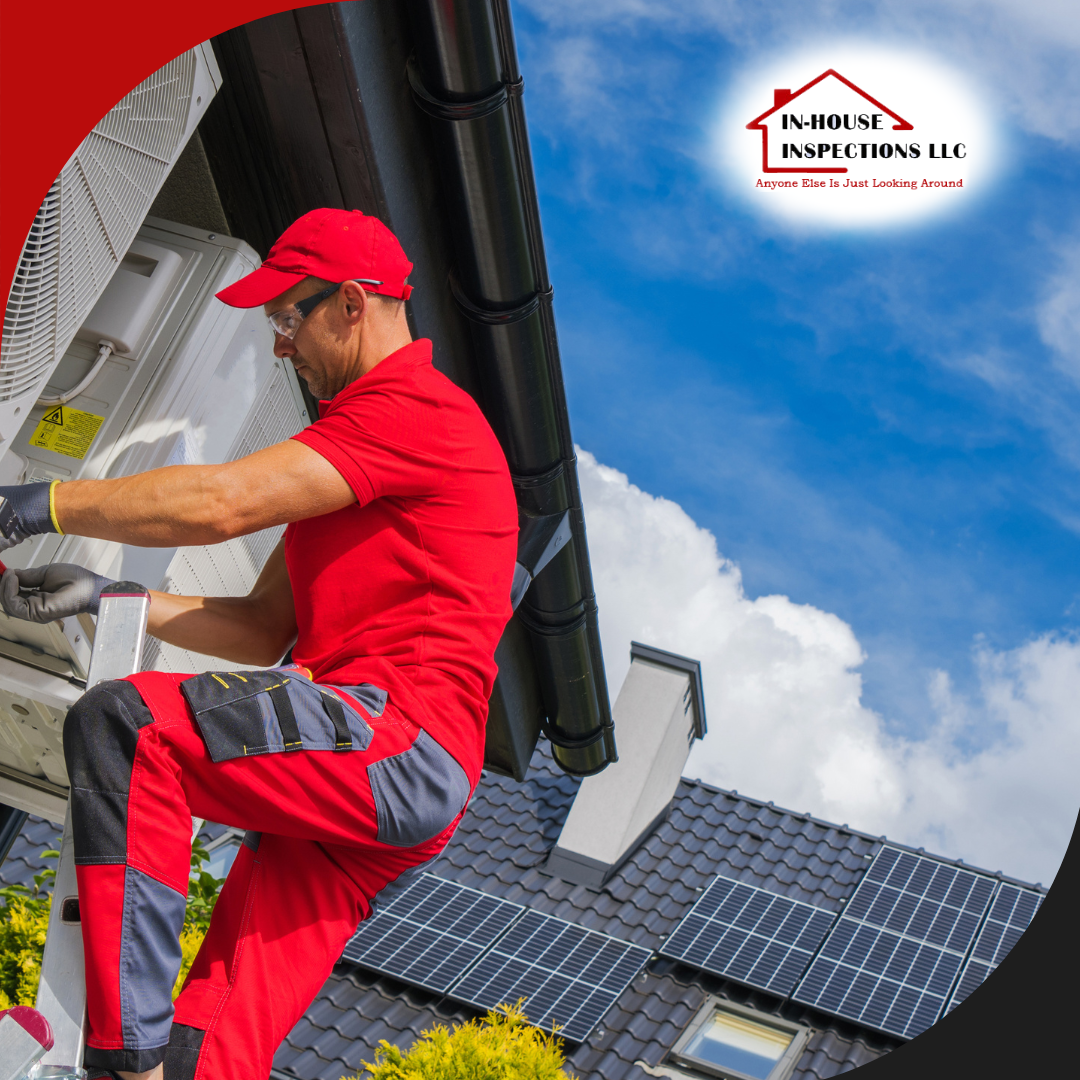 In-House Inspections LLC(1) A technician dressed in a red uniform is installing or servicing an outdoor air conditioning unit on the side of a house.