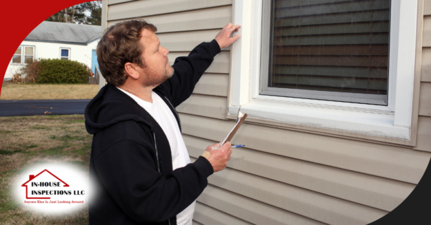 In-House Inspections LLC Inspector checking the condition of an exterior window frame with clipboard in hand.