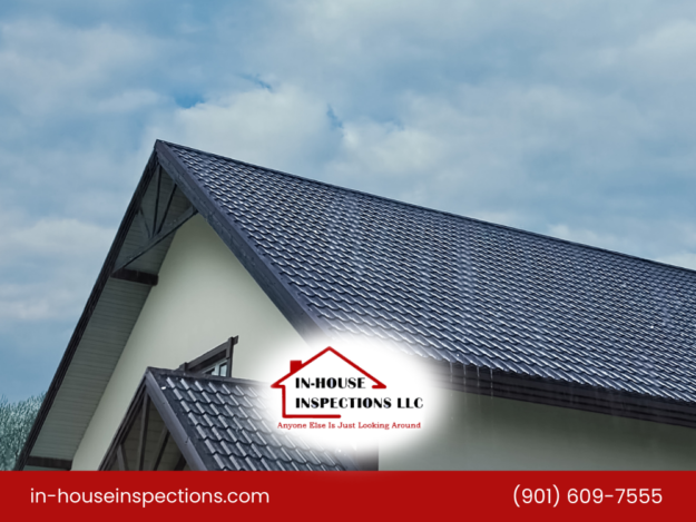Metal roof under cloudy skies showing proper drainage and structure.